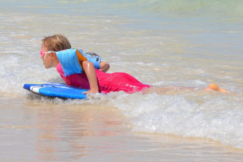 child on a surfing board